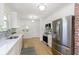 Modern kitchen with stainless steel appliances, white cabinets, and a stylish backsplash over a sleek countertop at 4226 Cornelius Ave, Indianapolis, IN 46208