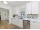 Bright kitchen featuring white cabinets, stainless steel appliances, modern backsplash and hardwood floors at 4226 Cornelius Ave, Indianapolis, IN 46208