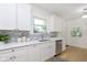A bright kitchen with white cabinets, stainless steel appliances, and a modern backsplash at 4226 Cornelius Ave, Indianapolis, IN 46208