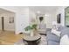 A bright and open living room with neutral walls, hardwood floors and grey couch and chair at 4226 Cornelius Ave, Indianapolis, IN 46208