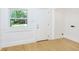 Bright room with a view to the backyard, featuring a window and white door at 4226 Cornelius Ave, Indianapolis, IN 46208