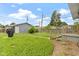 Backyard with a manicured lawn, wooden fence, and a detached one-car garage at 4813 E 11Th St, Indianapolis, IN 46201