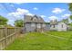 View of the backyard, with a well-maintained lawn, garden beds, and a detached garage at 4813 E 11Th St, Indianapolis, IN 46201