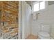 Bathroom shower with exposed brick and white tile at 4813 E 11Th St, Indianapolis, IN 46201