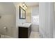Updated bathroom featuring a modern vanity with double sinks and tiled walls at 4813 E 11Th St, Indianapolis, IN 46201