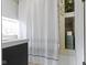 Bathroom showcasing a stylish shower curtain, tile accents, and a convenient built-in niche at 4813 E 11Th St, Indianapolis, IN 46201