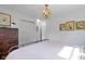 Bedroom with white walls, a gold metal bed frame, and vintage decorations at 4813 E 11Th St, Indianapolis, IN 46201