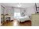 Cozy bedroom with a white-framed bed, charming desk, and ample natural light at 4813 E 11Th St, Indianapolis, IN 46201
