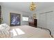 Bedroom with a gold metal bed frame, neutral bedding, and classic chandelier at 4813 E 11Th St, Indianapolis, IN 46201