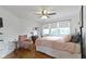 Comfortable bedroom with a pink chair, hardwood floors, and large windows at 4813 E 11Th St, Indianapolis, IN 46201