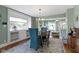 Bright dining area with window views and an open floor plan into a cozy living room space at 4813 E 11Th St, Indianapolis, IN 46201
