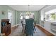 Elegant dining room featuring a statement chandelier and hardwood floors that connect to the kitchen at 4813 E 11Th St, Indianapolis, IN 46201