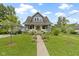 Charming home with a well-manicured lawn and beautiful hydrangea bushes lining the walkway at 4813 E 11Th St, Indianapolis, IN 46201