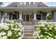 Inviting front porch with charming details and lush hydrangea, perfect for relaxing outdoors at 4813 E 11Th St, Indianapolis, IN 46201