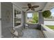 Relaxing front porch featuring comfortable seating and ceiling fan, ideal for enjoying the outdoors at 4813 E 11Th St, Indianapolis, IN 46201