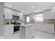 Modern kitchen with white cabinetry, stainless steel appliances, and butcher block countertops at 4813 E 11Th St, Indianapolis, IN 46201