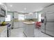 Clean, bright kitchen with butcher block countertops, white cabinets, and stainless steel appliances at 4813 E 11Th St, Indianapolis, IN 46201