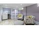 Cozy laundry room with sliding doors and includes a washer, dryer, and floral armchairs at 4813 E 11Th St, Indianapolis, IN 46201