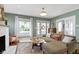 Bright living room with a decorative fireplace and large windows overlooking the garden at 4813 E 11Th St, Indianapolis, IN 46201