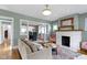 Comfortable living room with fireplace, plush seating, and an open view into the dining area at 4813 E 11Th St, Indianapolis, IN 46201