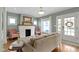 Welcoming living room features fireplace, hardwood floors, and an inviting entry and exit at 4813 E 11Th St, Indianapolis, IN 46201
