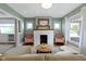 Stylish living room featuring a brick fireplace, hardwood floors, and comfortable pink seating at 4813 E 11Th St, Indianapolis, IN 46201