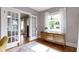 Bright living room boasts hardwood floors, a large window, and elegant French doors at 4813 E 11Th St, Indianapolis, IN 46201