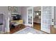 Office featuring a desk, chair, hardwood floors, and French doors at 4813 E 11Th St, Indianapolis, IN 46201