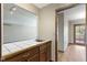 This bar area includes wooden cabinets, sink, and a tile countertop, connecting to other living spaces at 5037 Surrey Ln, Carmel, IN 46033