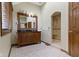 Bright bathroom with a double sink vanity, large mirror, tiled floors, and tiled shower area at 5037 Surrey Ln, Carmel, IN 46033