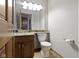 Bathroom featuring a wooden vanity with granite countertop, toilet, and a large mirror at 5037 Surrey Ln, Carmel, IN 46033