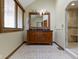 Primary bathroom featuring a double vanity, a large mirror, and a separate tiled shower at 5037 Surrey Ln, Carmel, IN 46033