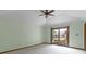 The bedroom has a ceiling fan and sliding glass doors that lead to a patio with a hot tub at 5037 Surrey Ln, Carmel, IN 46033
