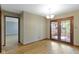 Bright dining room with hardwood floors and access to a screened-in porch through wooden framed glass doors at 5037 Surrey Ln, Carmel, IN 46033