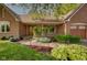 Beautiful brick home with meticulous landscaping and inviting walkway to the front door at 5037 Surrey Ln, Carmel, IN 46033