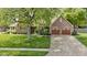 Charming brick home features a well-manicured lawn, mature trees, and a two-car garage at 5037 Surrey Ln, Carmel, IN 46033
