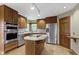 Well-lit kitchen featuring stainless steel appliances and an island at 5037 Surrey Ln, Carmel, IN 46033