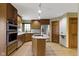 Kitchen features stainless steel appliances, wood cabinets, and an island at 5037 Surrey Ln, Carmel, IN 46033