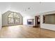 Bright living room showcasing hardwood floors, a fireplace, and a large window at 5037 Surrey Ln, Carmel, IN 46033