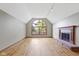 Open living area with hardwood floors, fireplace, and a large arched window at 5037 Surrey Ln, Carmel, IN 46033