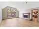 Bright living room with hardwood floors, fireplace, and large arched window at 5037 Surrey Ln, Carmel, IN 46033