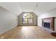 Living room showcasing hardwood floors, fireplace, and large arched window at 5037 Surrey Ln, Carmel, IN 46033