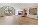 Living room featuring hardwood floors, fireplace, and a large arched window at 5037 Surrey Ln, Carmel, IN 46033