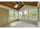 Screened-in porch showcasing a wood ceiling, skylight, and great natural light, ideal for comfortable outdoor living at 5037 Surrey Ln, Carmel, IN 46033