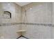 Tiled shower features a hand held shower head, a corner shelf and mosaic accents at 5037 Surrey Ln, Carmel, IN 46033