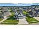Wide aerial shot of a residential community, displaying manicured lawns and a mix of houses with varying architectural designs at 5668 Champion Way, Greenwood, IN 46143