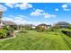 Expansive backyard featuring a playset, lush green lawn, and manicured landscaping perfect for Gathering fun at 5668 Champion Way, Greenwood, IN 46143