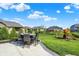 Landscaped backyard featuring a patio area, outdoor furniture, a play set and grass at 5668 Champion Way, Greenwood, IN 46143
