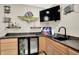 This bar area is equipped with stylish decor, a refrigerator and ample counter space at 5668 Champion Way, Greenwood, IN 46143