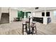 Open basement with a bar, a bar table with chairs, a couch, and a game table at 5668 Champion Way, Greenwood, IN 46143